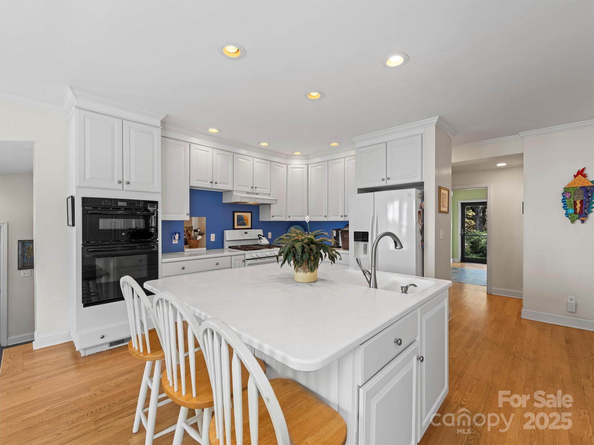 7 Park Road Asheville, NC 28803 - Photo 14 of 48 a kitchen with stainless steel appliances kitchen island granite countertop a refrigerator and a stove top oven
