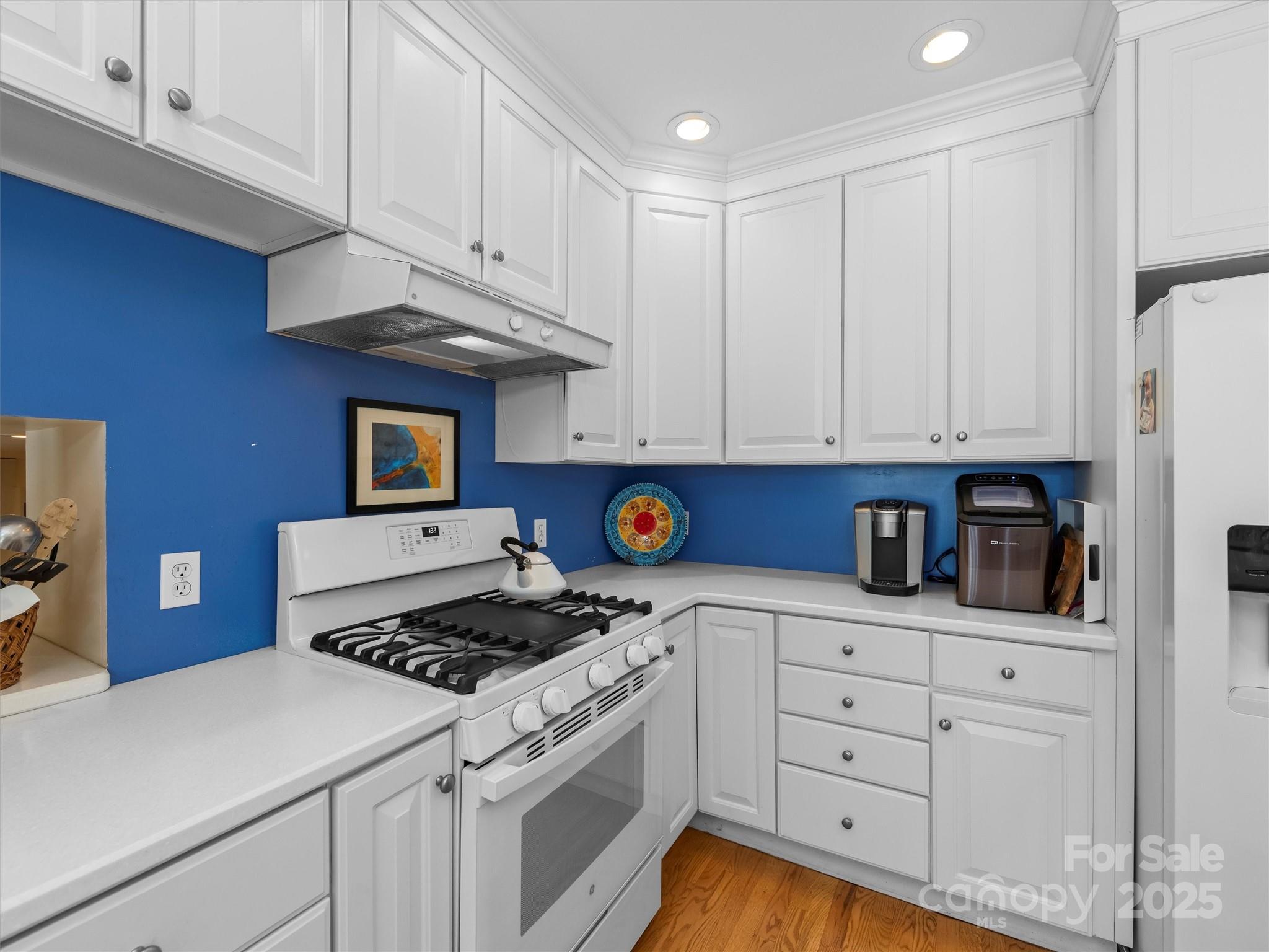 7 Park Road Asheville, NC 28803 - Photo 15 of 48 a kitchen with white cabinets and appliances