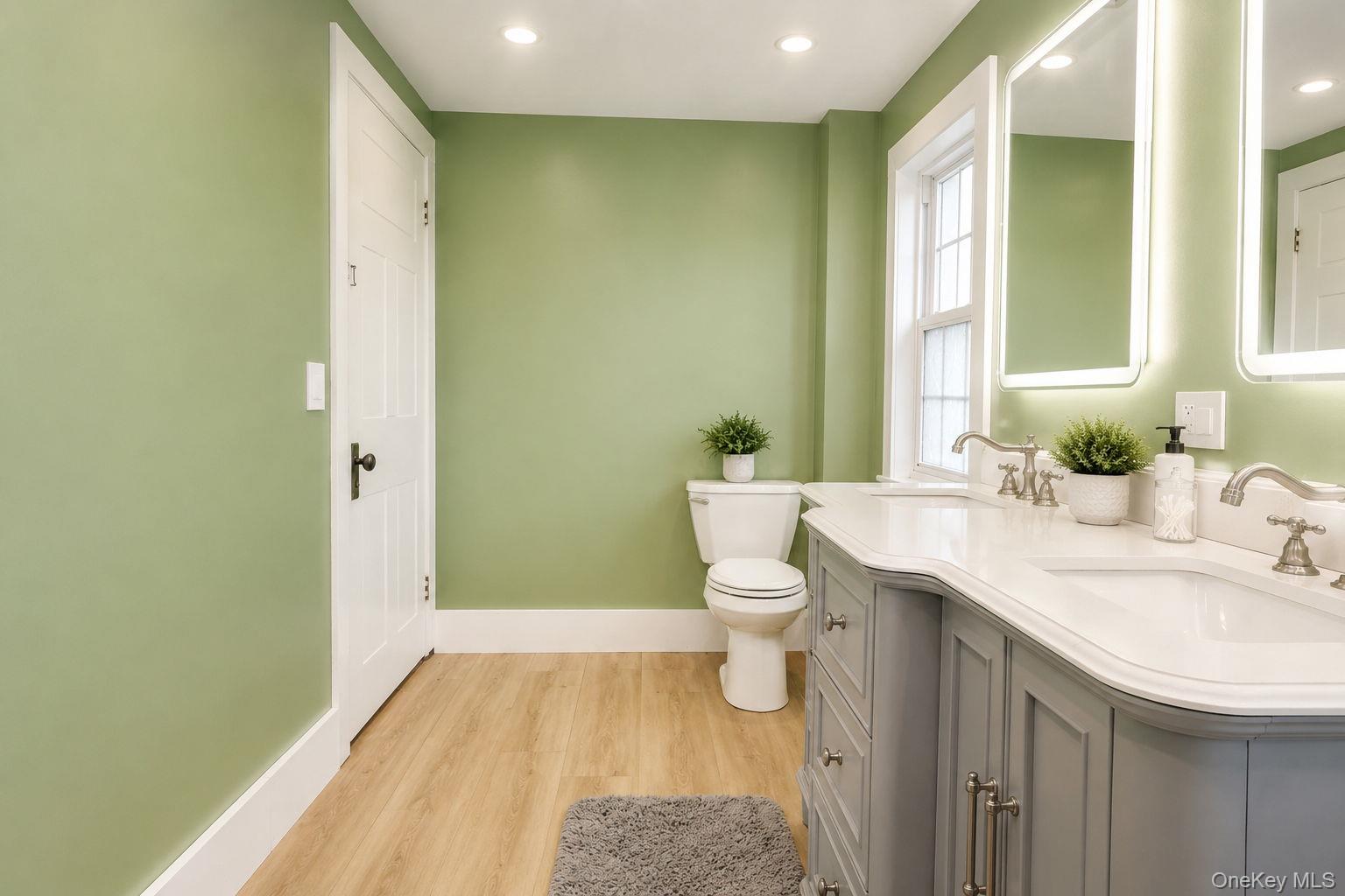 340 Dunn Road Montgomery, NY 12549 - Photo 21 of 34 View of the double vanity and toilet with vinyl plank flooring