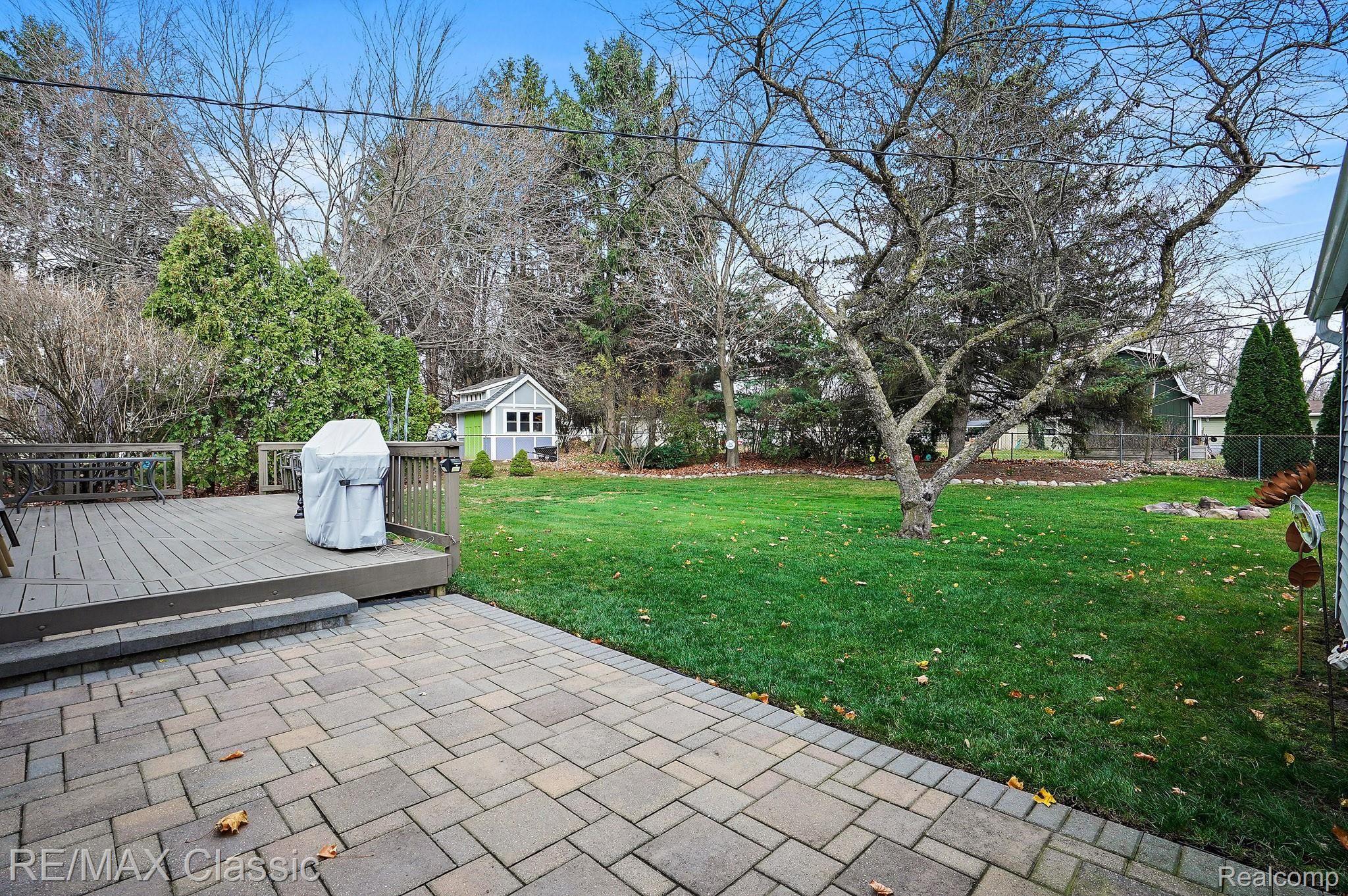 1396 Decker Road Walled Lake, MI 48390 - Photo 4 of 19 Back Yard Deck and Brick Patio