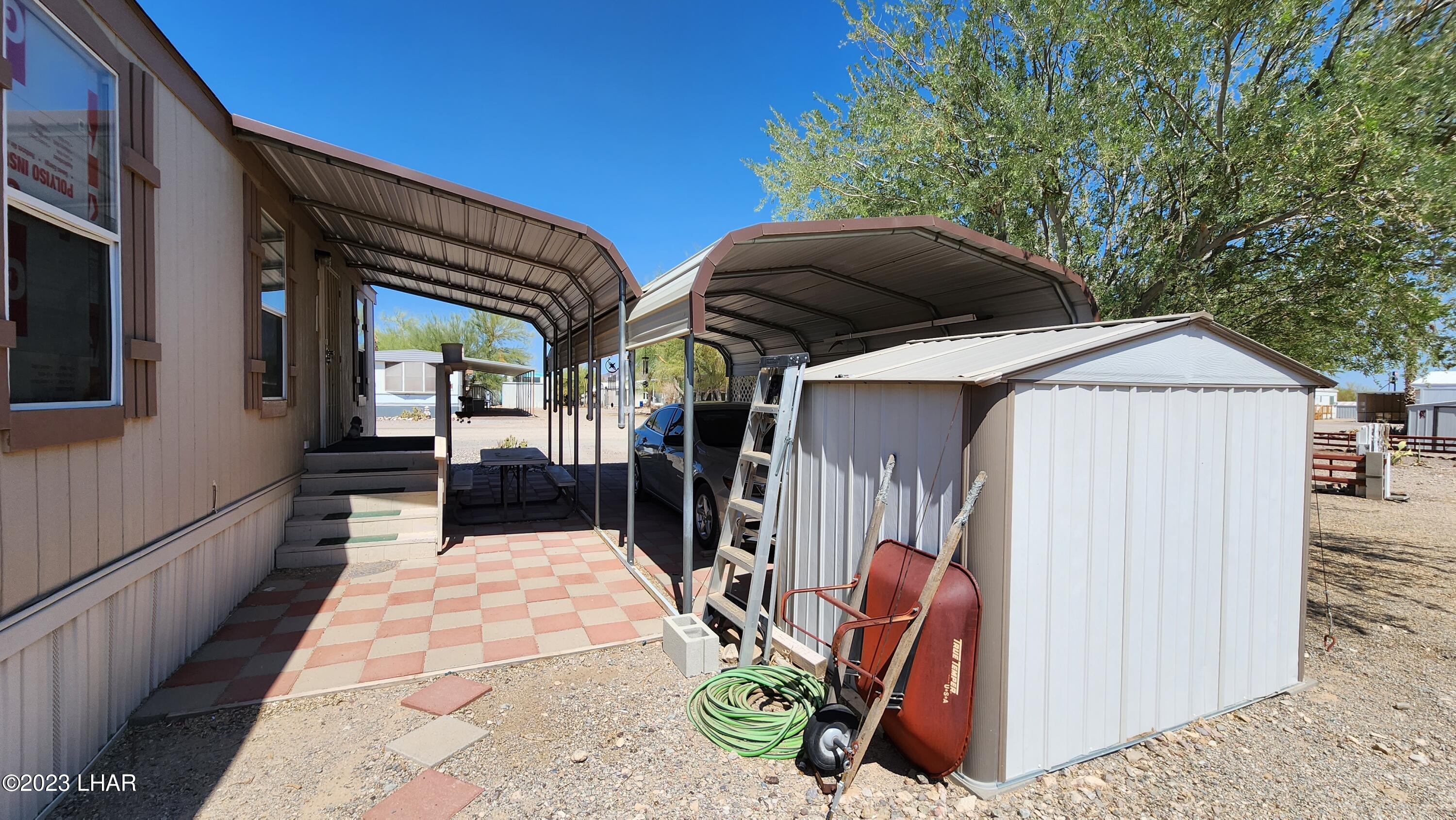 1240 Acacia Road, Unit 155 Quartzsite, AZ 85346 - Photo 14 of 21 Covered front door entrance, primary carport & storage shed
