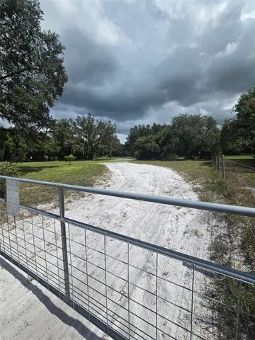 a view of outdoor space with swimming pool and trees in the background