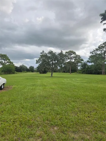 a view of a green field with clear sky