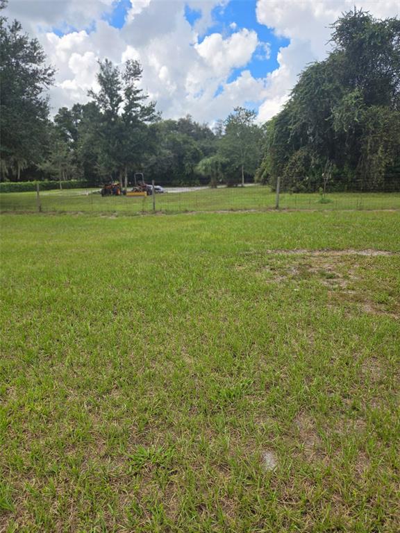885 Lake Marian Road Kenansville, FL 34739 - Photo 6 of 11 a view of outdoor space with deck and yard