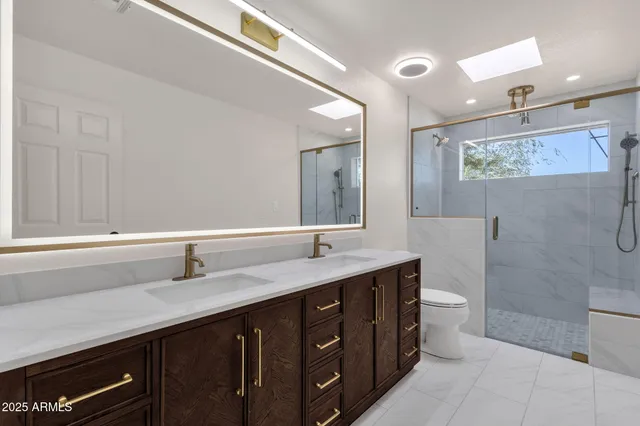 a bathroom with a double vanity sink and mirror