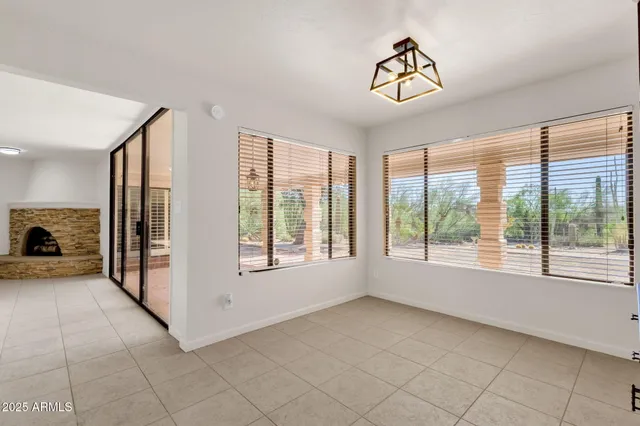 a view of a livingroom with a ceiling fan and window
