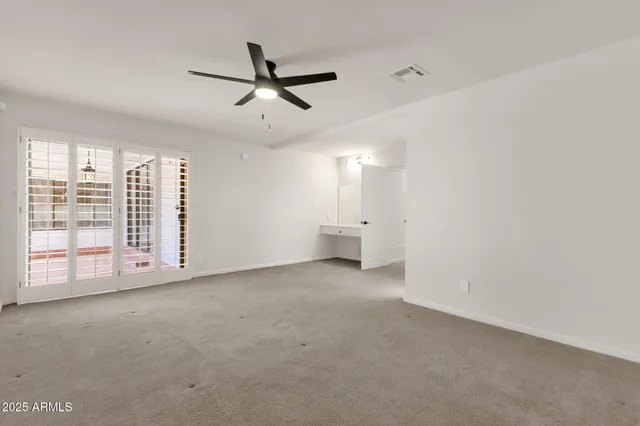 a view of an empty room with windows