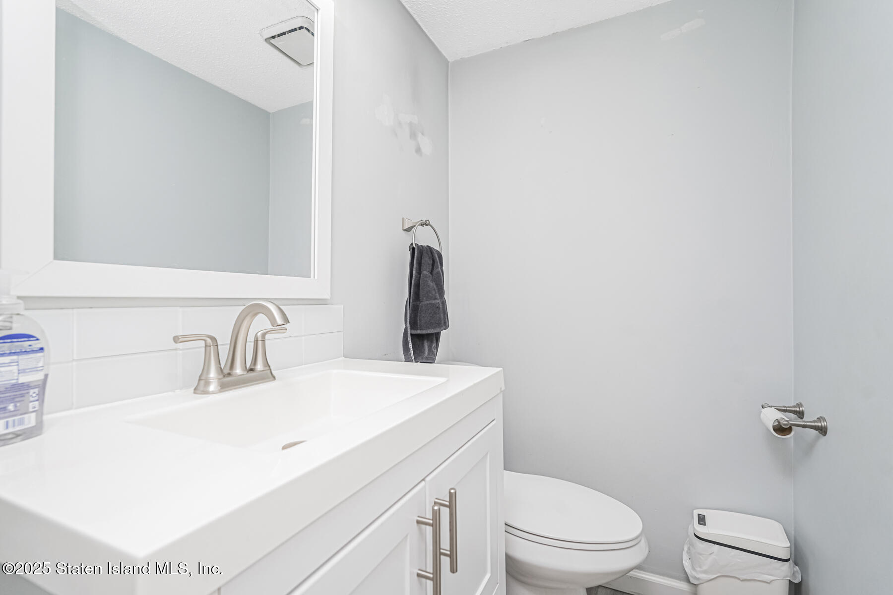 70 Ilyssa Way Staten Island, NY 10312 - Photo 19 of 39 a bathroom with a sink a toilet and mirror