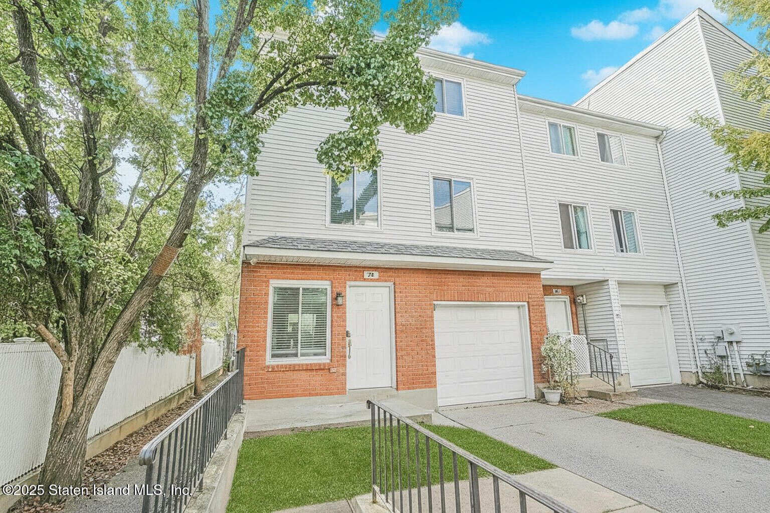 70 Ilyssa Way Staten Island, NY 10312 - Photo 2 of 39 a front view of a house with a garden and yard