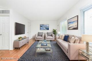 70 Ilyssa Way Staten Island, NY 10312 - Photo 21 of 39 a living room with furniture and a flat screen tv