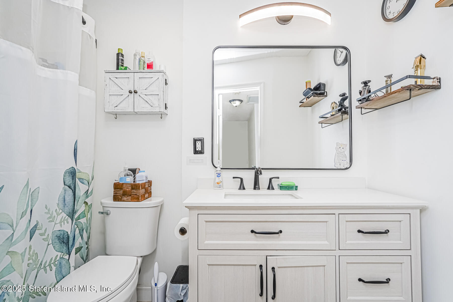 70 Ilyssa Way Staten Island, NY 10312 - Photo 29 of 39 a bathroom with a sink vanity mirror and toilet