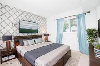 70 Ilyssa Way Staten Island, NY 10312 - Photo 3 of 39 a bedroom with a bed and a flat screen tv