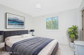 70 Ilyssa Way Staten Island, NY 10312 - Photo 37 of 39 a bedroom with a large bed and a potted plant