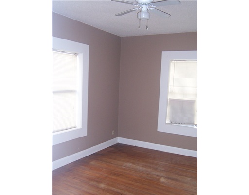 1224 2nd Street, Unit 3 Corpus Christi, TX 78404 - Photo 7 of 9 a view of an empty room with wooden floor and a window