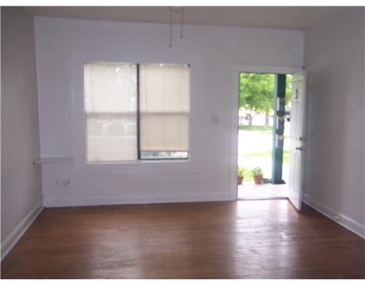 1224 2nd Street, Unit 3 Corpus Christi, TX 78404 - Photo 8 of 9 an empty room with wooden floor and windows