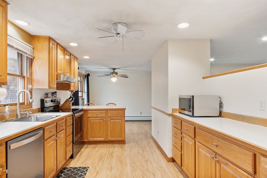 6 Colgate Street Danvers, MA 01923 - Photo 13 of 38 a kitchen with stainless steel appliances a sink stove and cabinets