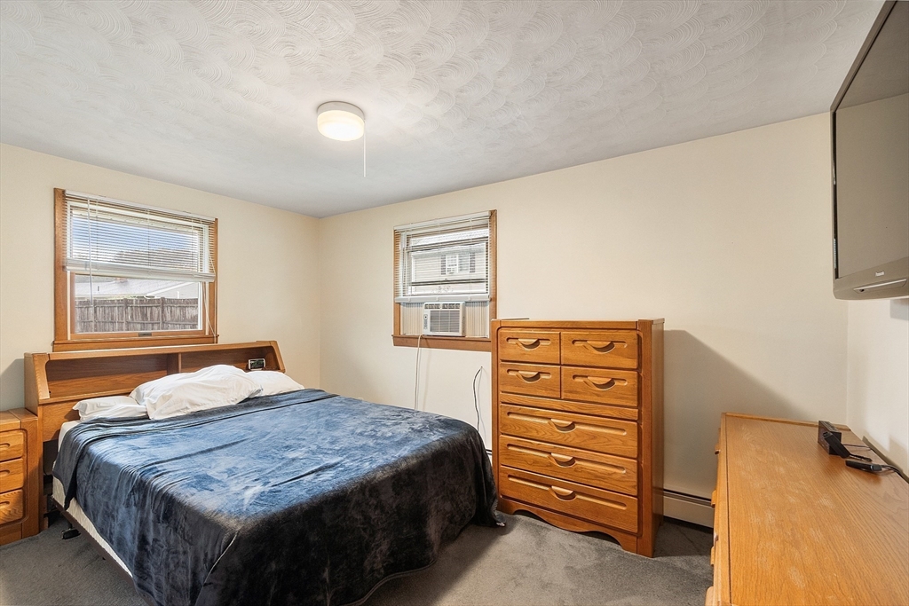 6 Colgate Street Danvers, MA 01923 - Photo 19 of 38 a bedroom with a bed and a dresser