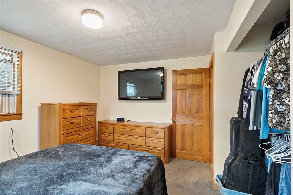 6 Colgate Street Danvers, MA 01923 - Photo 20 of 38 a bedroom with a bed and flat tv screen