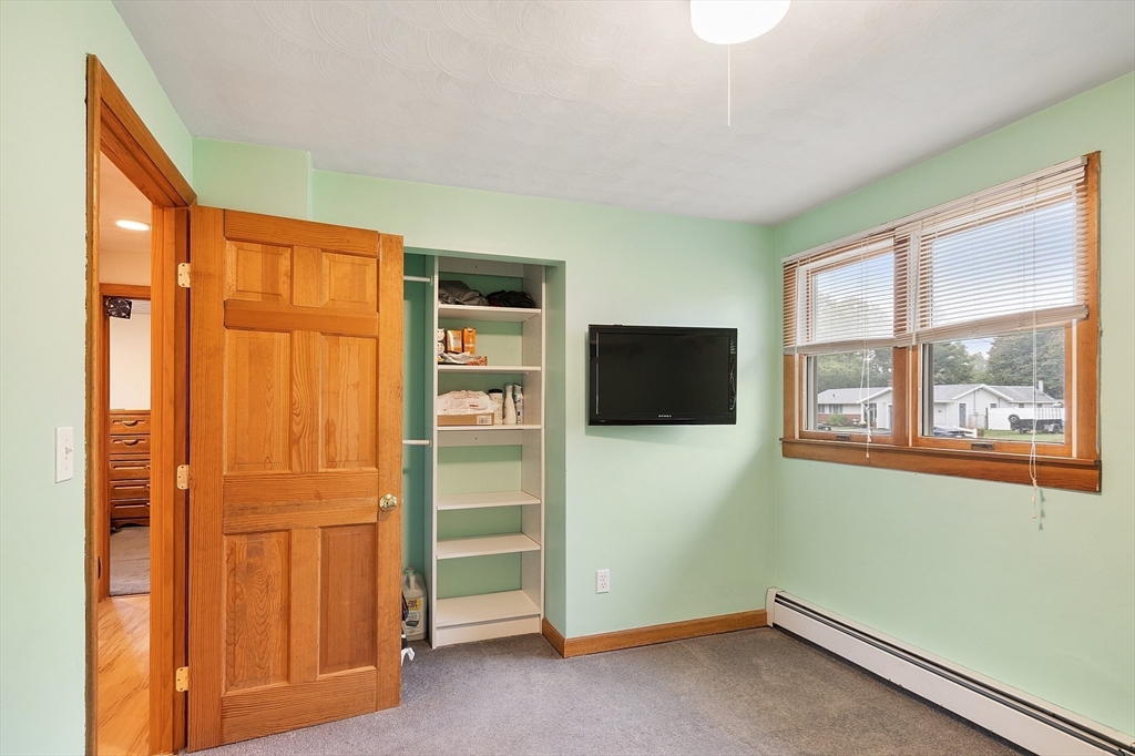 6 Colgate Street Danvers, MA 01923 - Photo 23 of 38 an empty room with windows cabinet and flat screen tv