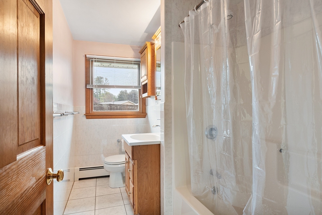 6 Colgate Street Danvers, MA 01923 - Photo 28 of 38 a bathroom with a window and a shower