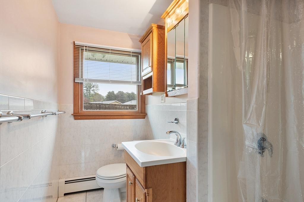 6 Colgate Street Danvers, MA 01923 - Photo 29 of 38 a bathroom with a toilet a sink and a window