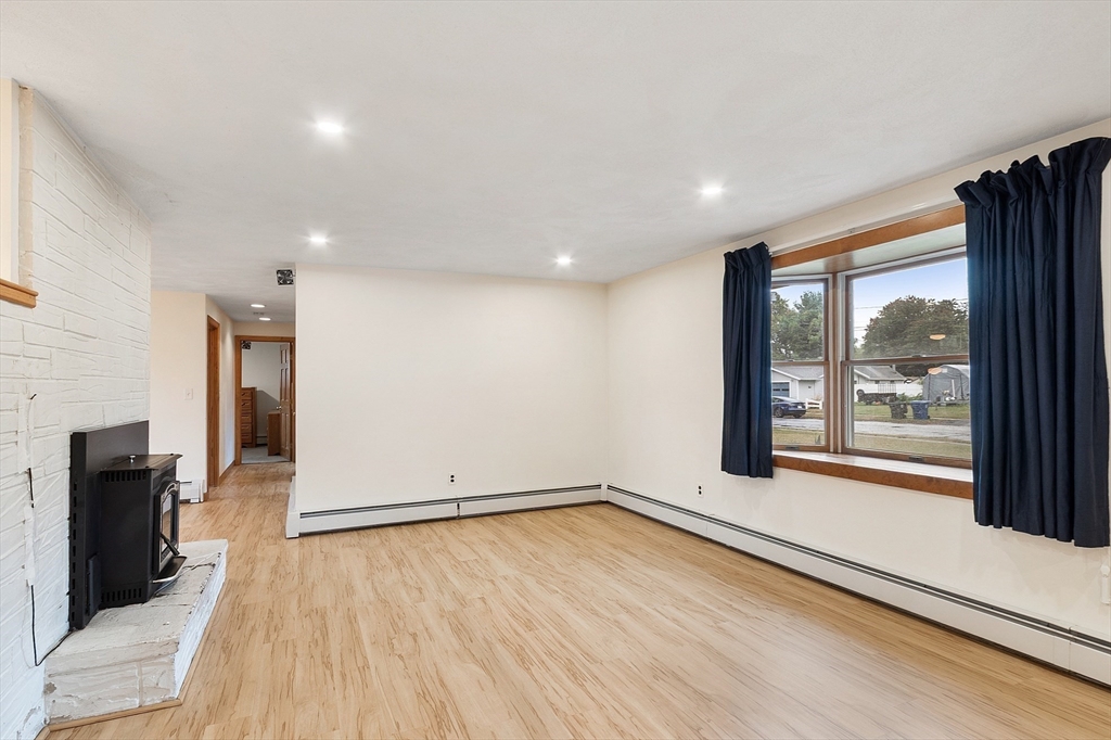6 Colgate Street Danvers, MA 01923 - Photo 5 of 38 a view of empty room with wooden floor and fireplace