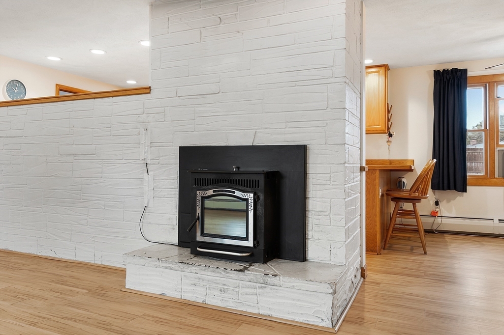 6 Colgate Street Danvers, MA 01923 - Photo 8 of 38 a living room with a fireplace in it