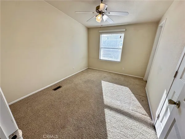 view of room with window and ceiling fan