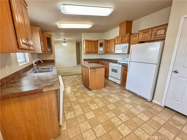 a kitchen with a refrigerator sink and stove