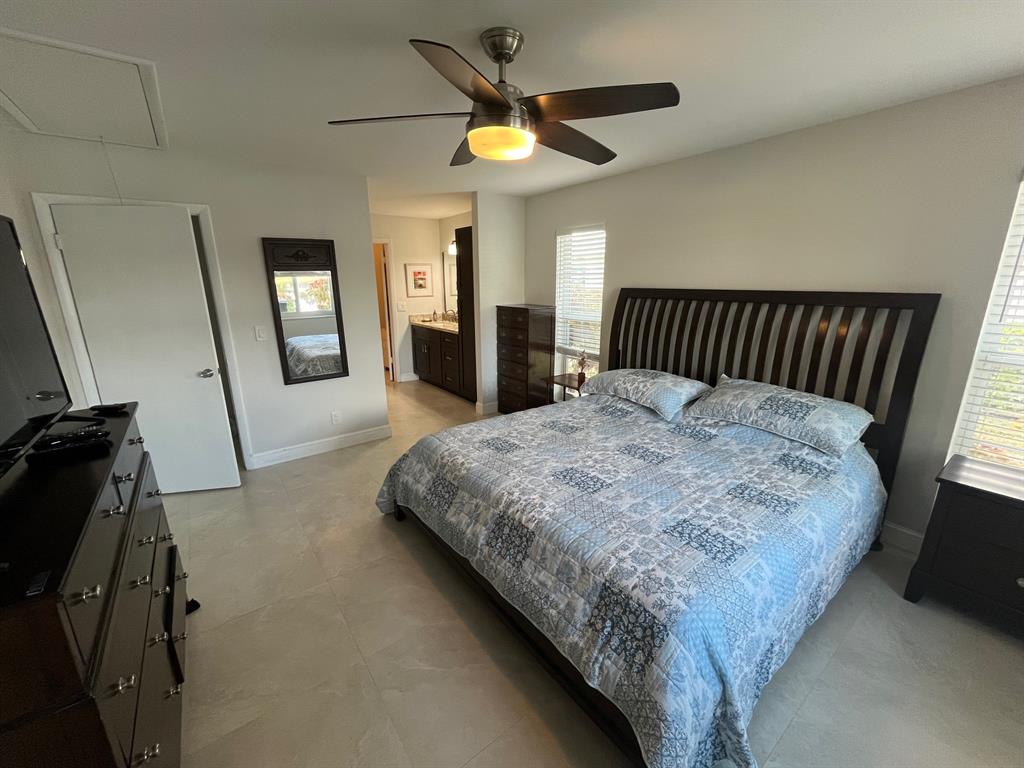 8777 Warwick Drive, Unit 265 Boca Raton, FL 33433 - Photo 12 of 31 a bed sitting in a bedroom next to a window