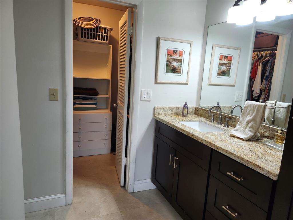8777 Warwick Drive, Unit 265 Boca Raton, FL 33433 - Photo 15 of 31 a bathroom with a granite countertop sink and a mirror