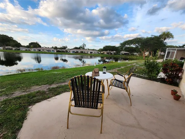 a bedroom with a bed and a flat tv screen on dresser
