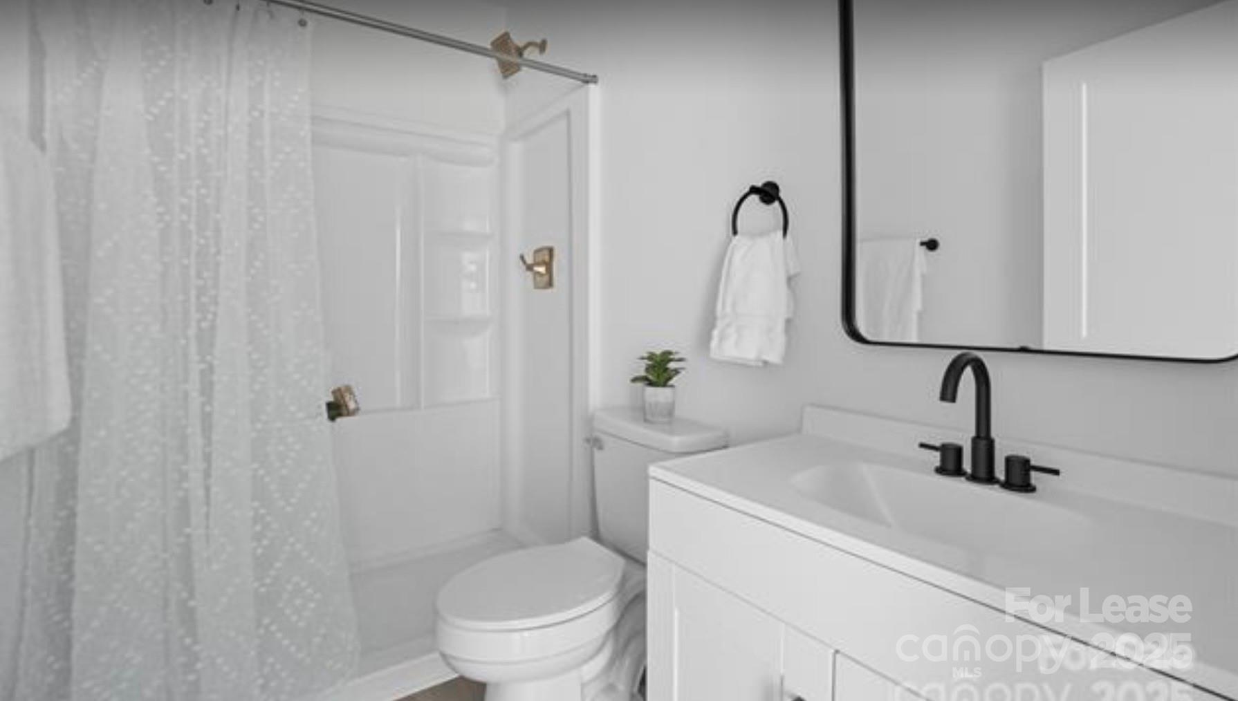 64 Brumley Avenue Northeast Concord, NC 28025 - Photo 12 of 19 a bathroom with a sink a toilet and shower