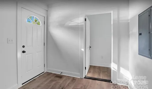 a view of an entryway with wooden floor