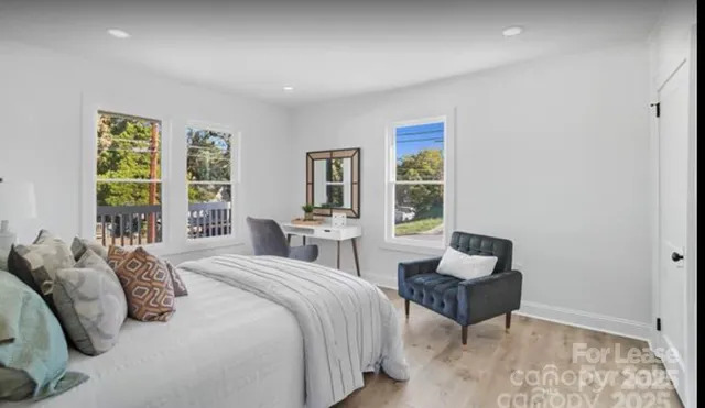 a spacious bedroom with a bed and a couch