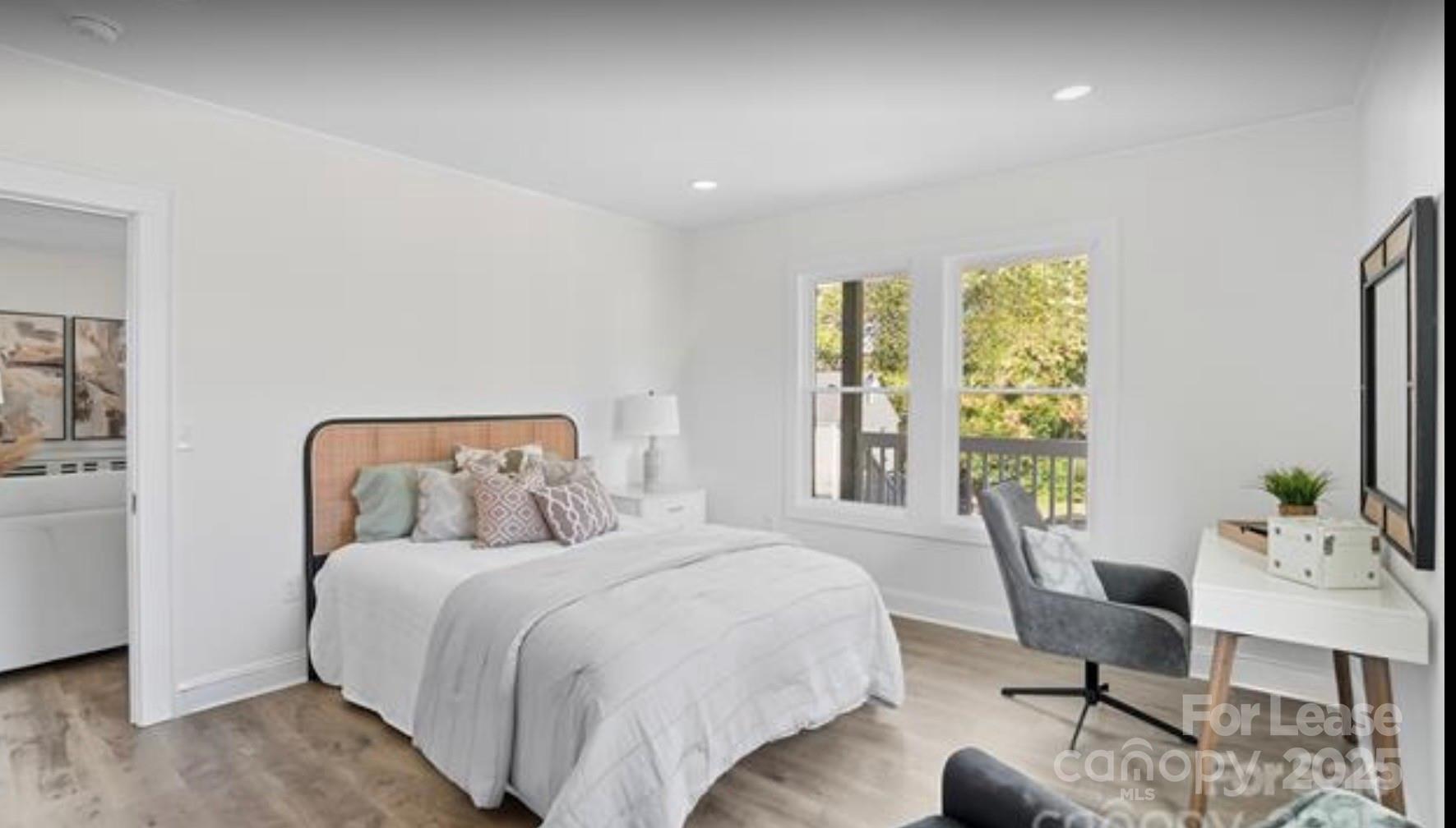 64 Brumley Avenue Northeast Concord, NC 28025 - Photo 8 of 19 a bed room with a bed and a chair