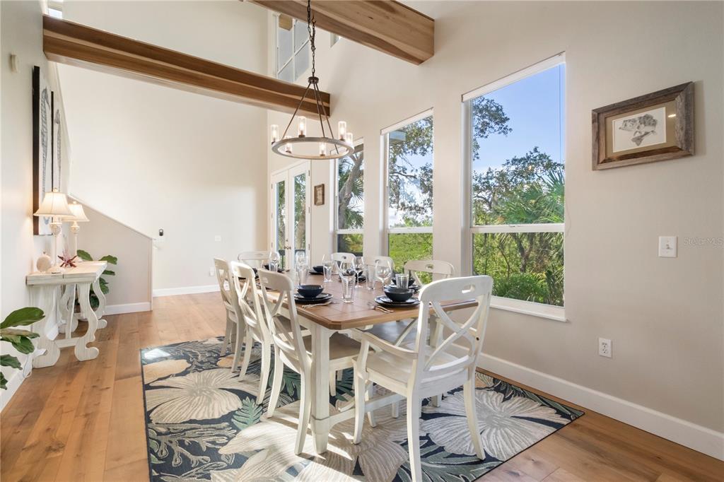 7325 Holly Road Terra Ceia, FL 34250 - Photo 16 of 87 a view of a dining room with furniture window and wooden floor