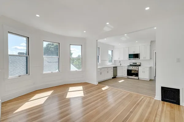 a view of a kitchen with stove and cabinets