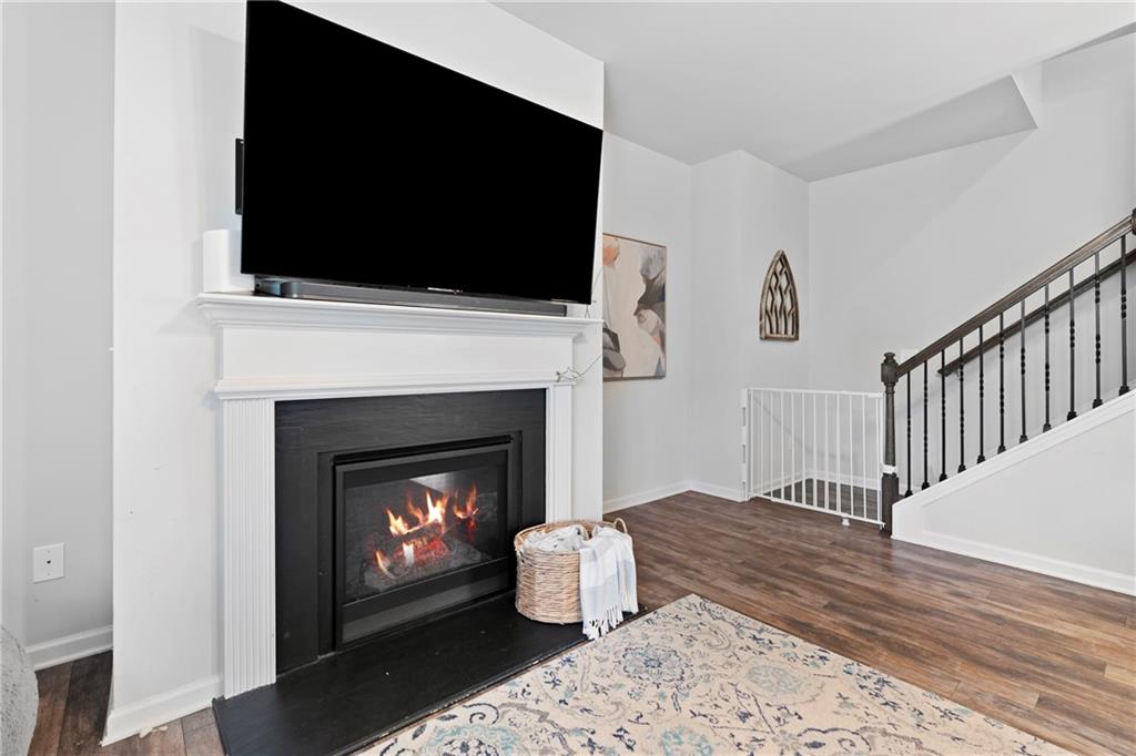511 Autumn Echo Canton, GA 30114 - Photo 11 of 45 a living room with a fireplace and a flat screen tv
