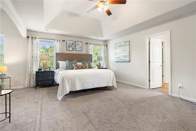 a bedroom with bed and a large window