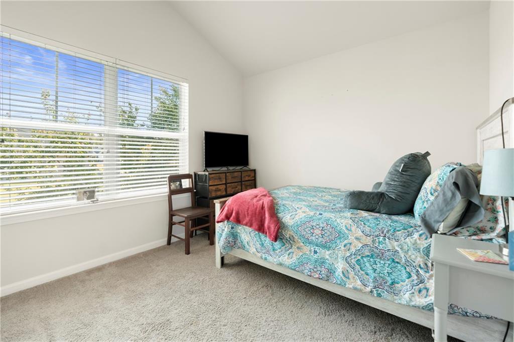 511 Autumn Echo Canton, GA 30114 - Photo 25 of 45 a bedroom with a bed and a flat screen tv