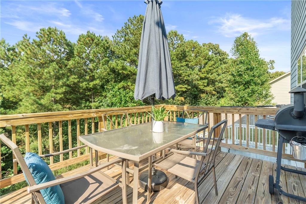 511 Autumn Echo Canton, GA 30114 - Photo 34 of 45 a view of a balcony with wooden floor and outdoor seating
