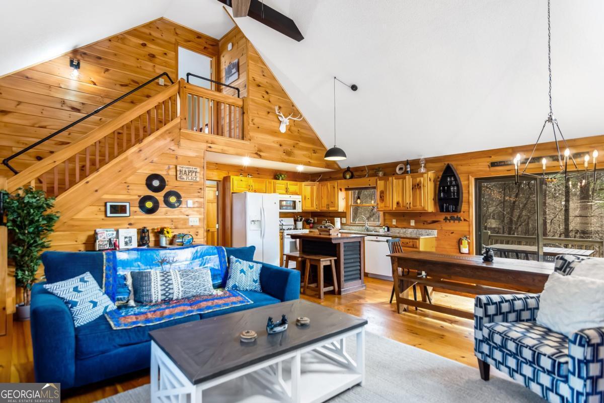174 Seneca Way, Unit 116 Ellijay, GA 30540 - Photo 21 of 39 a living room with furniture and large windows