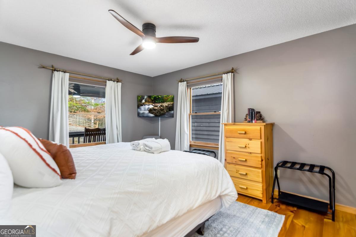 174 Seneca Way, Unit 116 Ellijay, GA 30540 - Photo 22 of 39 a bedroom with a bed and wooden floor