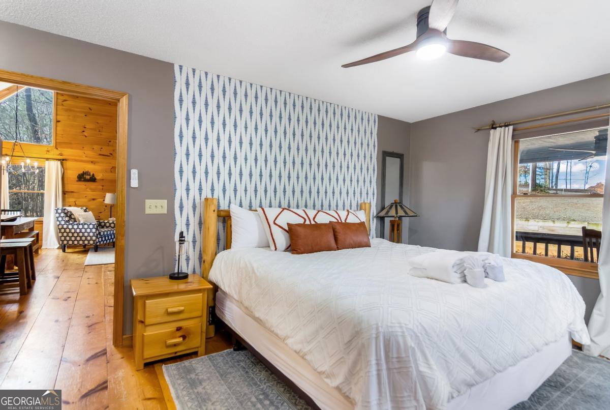 174 Seneca Way, Unit 116 Ellijay, GA 30540 - Photo 23 of 39 a bedroom with a bed and wooden floor