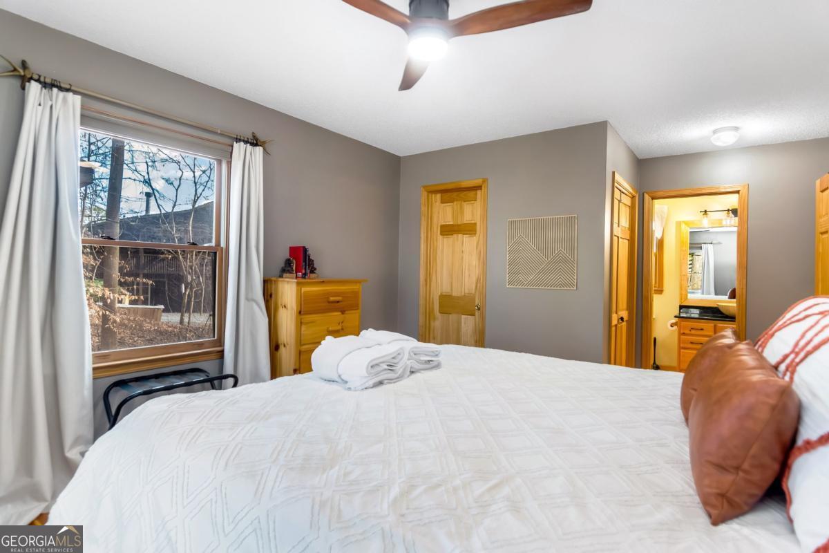 174 Seneca Way, Unit 116 Ellijay, GA 30540 - Photo 25 of 39 a bedroom with a bed and wooden floor