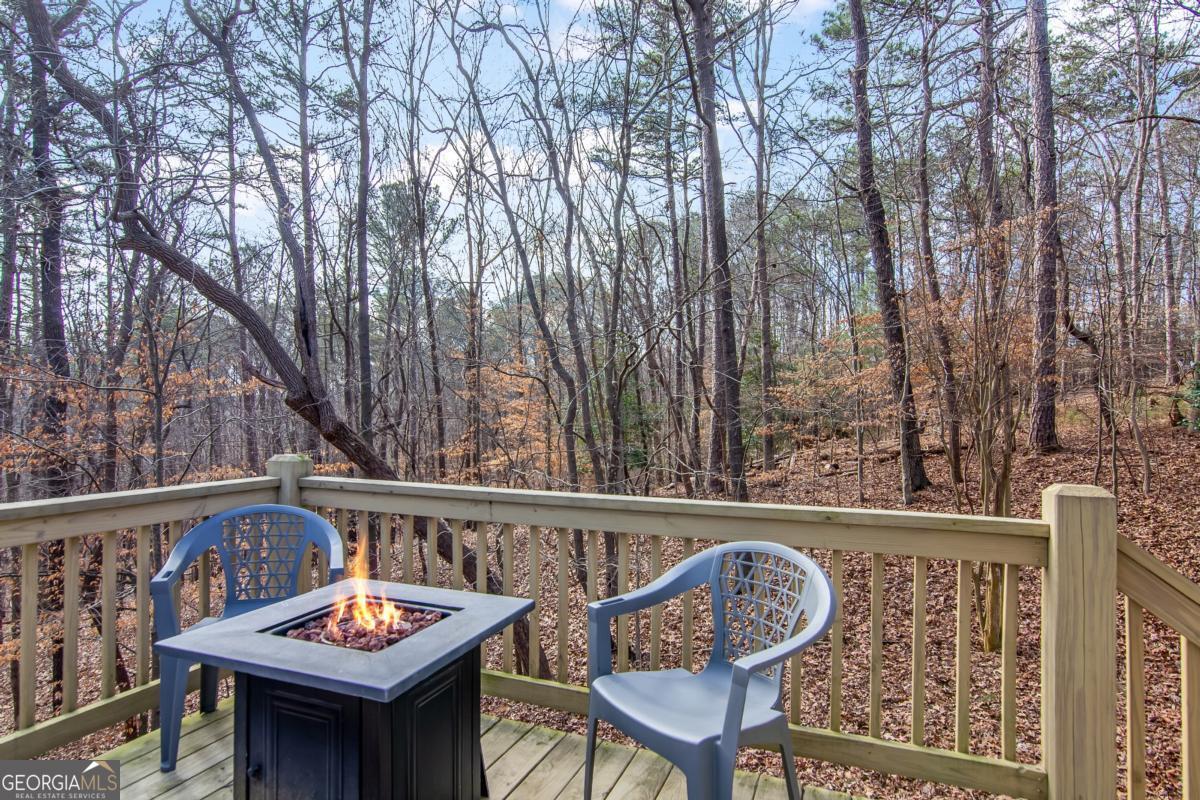 174 Seneca Way, Unit 116 Ellijay, GA 30540 - Photo 28 of 39 a view of a chairs and table on the deck