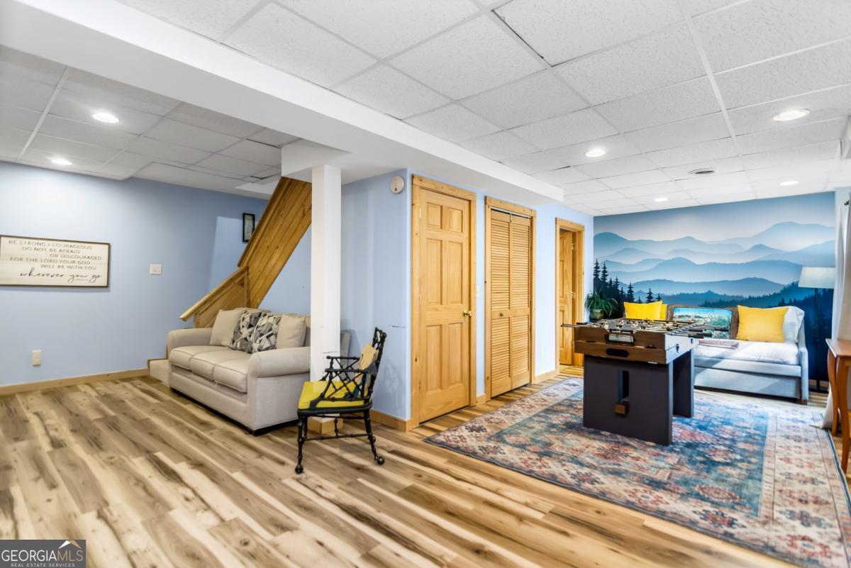 174 Seneca Way, Unit 116 Ellijay, GA 30540 - Photo 34 of 39 a living room with furniture and a wooden floor