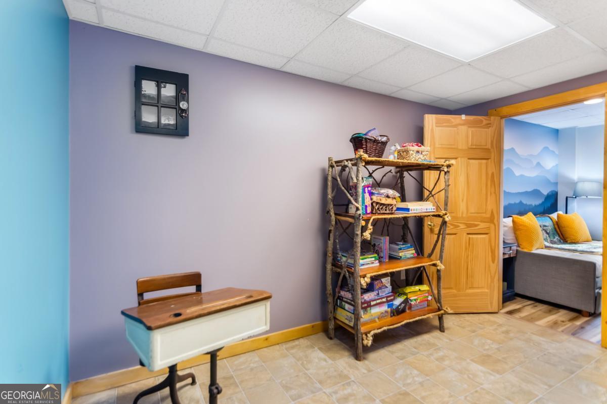 174 Seneca Way, Unit 116 Ellijay, GA 30540 - Photo 36 of 39 a bedroom with furniture and a book shelf