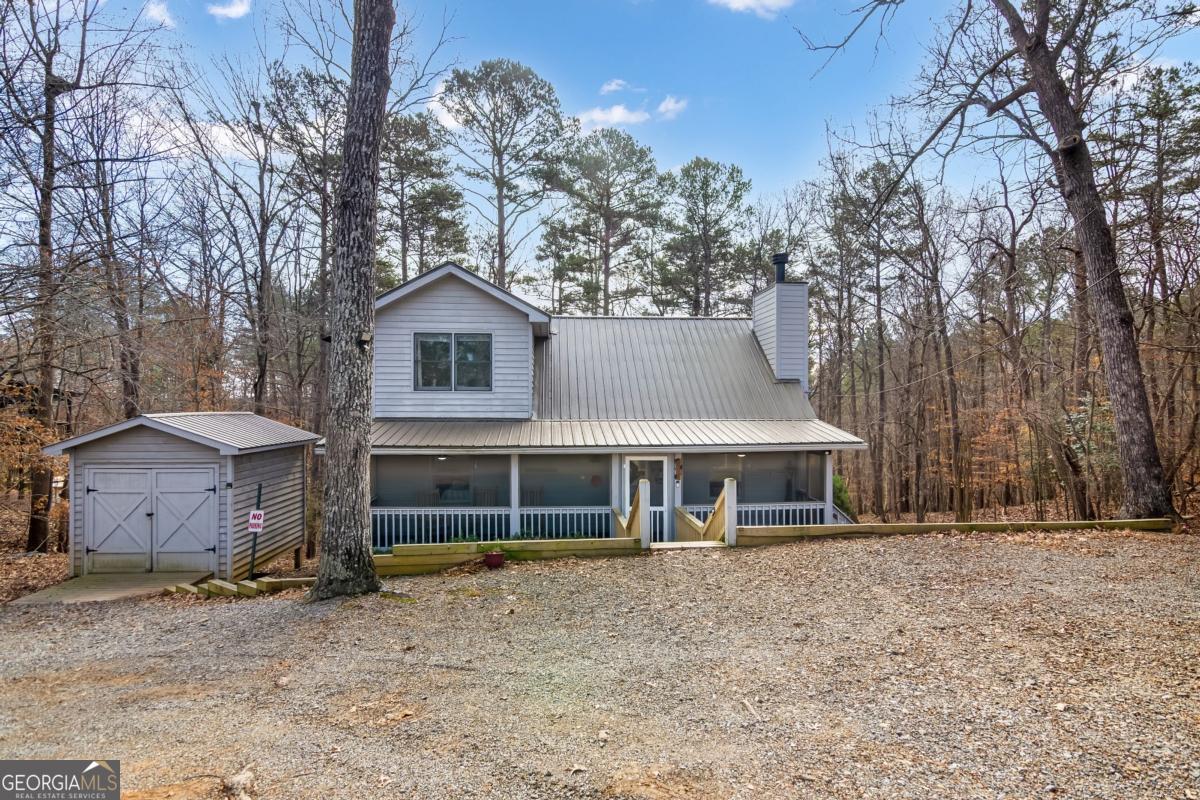 174 Seneca Way, Unit 116 Ellijay, GA 30540 - Photo 39 of 39 a front view of a house with a garden and trees